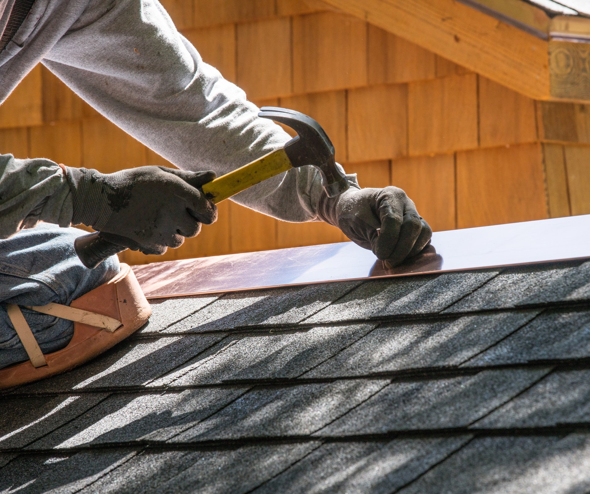 Repairing roof. Nailing flashing